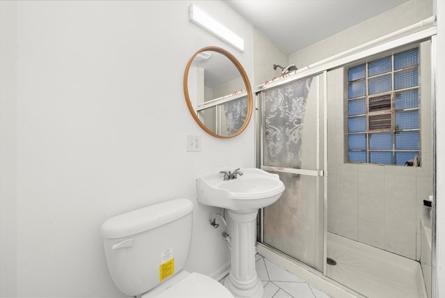 8100 South Houston Avenue Chicago, IL 60617 - Photo 22 of 55 a bathroom with a sink toilet and a mirror