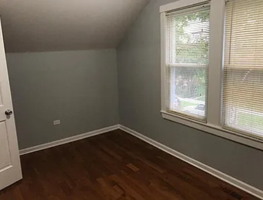 8100 South Houston Avenue Chicago, IL 60617 - Photo 36 of 55 a view of a small space with wooden floor and a window