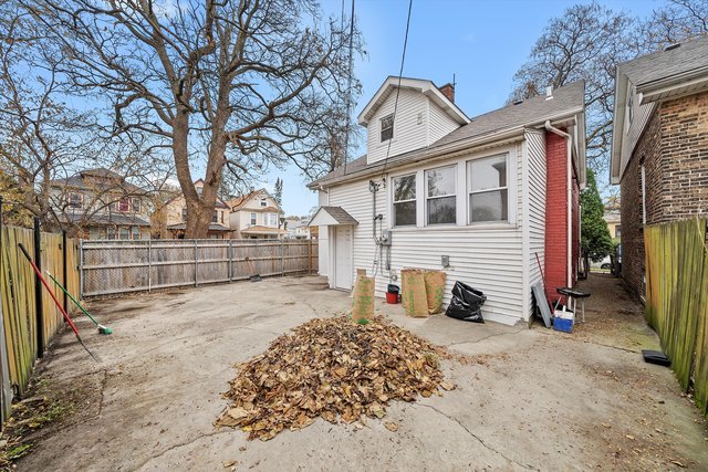 8100 South Houston Avenue Chicago, IL 60617 - Photo 43 of 55 a view of a house with a wooden fence next to a road