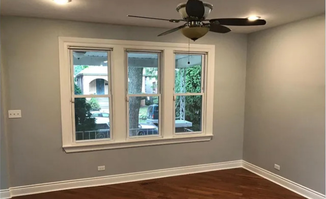 8100 South Houston Avenue Chicago, IL 60617 - Photo 9 of 55 a view of an empty room with a window and wooden floor