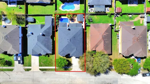 an aerial view of multiple houses with a yard