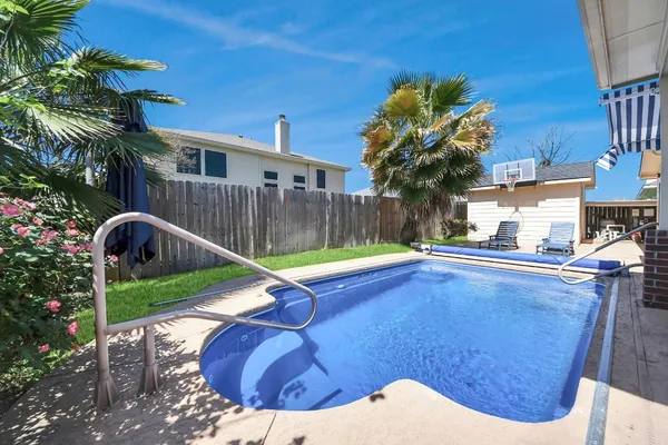 a wooden bench sitting in front of a building