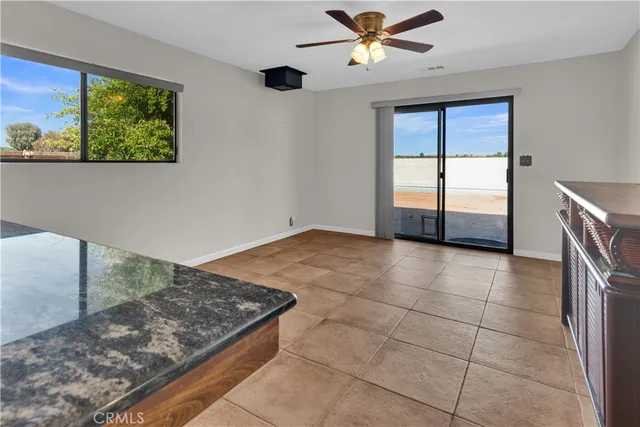 a view of kitchen with furniture and a ceiling fan