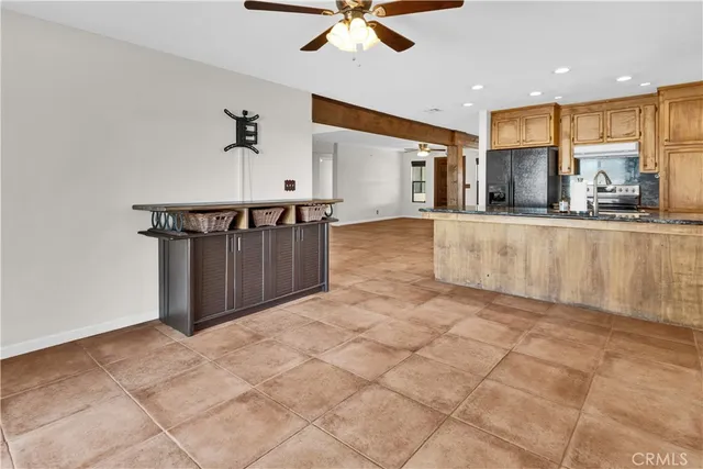 a large kitchen with kitchen island granite countertop a large counter top stainless steel appliances and cabinets