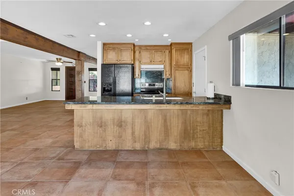 a kitchen with stainless steel appliances granite countertop a stove a sink and a refrigerator