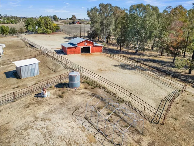 an aerial view of a house with a yard and lake view