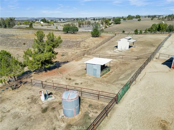 an aerial view of a house with a yard and lake view