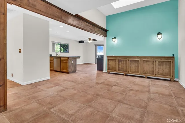 a view of a livingroom with a ceiling fan and window