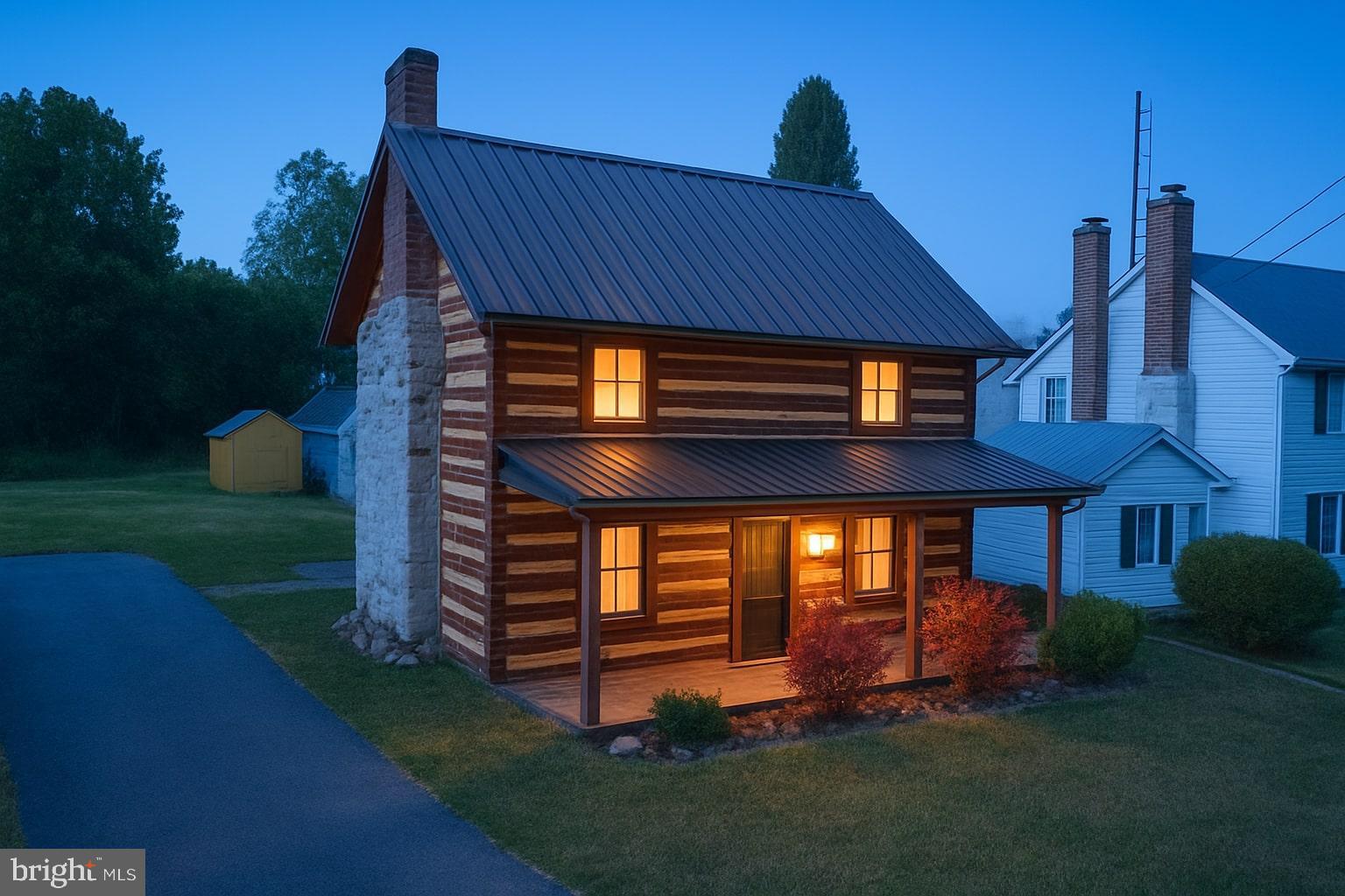 36 Runnymeade Road Bunker Hill, WV 25413 - Photo 1 of 45 Charming log cabin aglow at twilight.