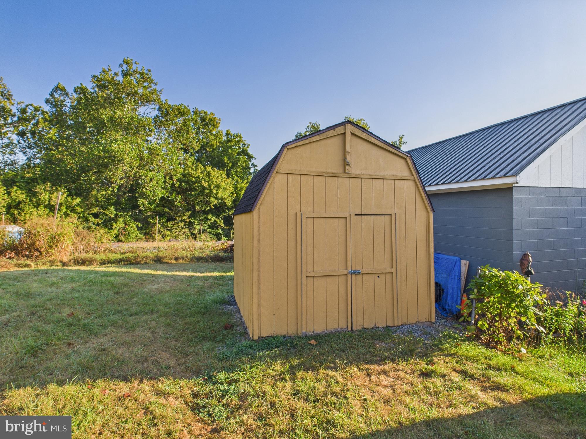 36 Runnymeade Road Bunker Hill, WV 25413 - Photo 10 of 45 Charming shed nestled in a serene landscape.