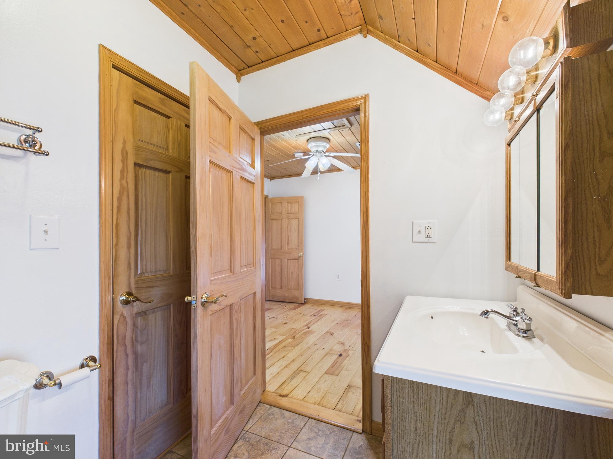 36 Runnymeade Road Bunker Hill, WV 25413 - Photo 30 of 45 Charming bathroom with rustic wood accents.