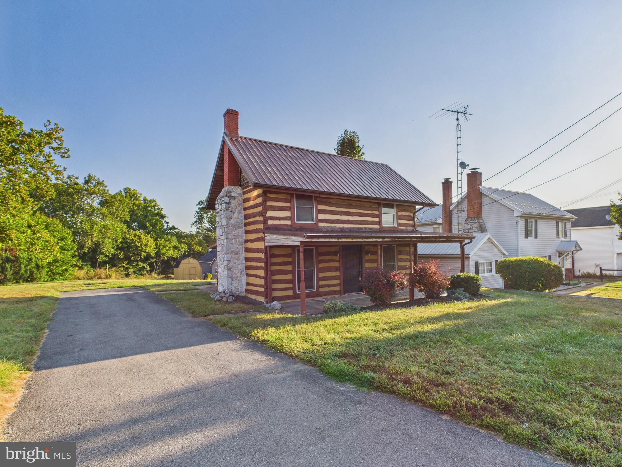 36 Runnymeade Road Bunker Hill, WV 25413 - Photo 4 of 45 Charming log cabin with scenic surroundings.