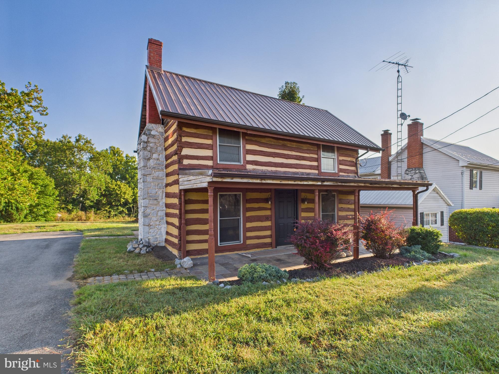 36 Runnymeade Road Bunker Hill, WV 25413 - Photo 6 of 45 Charming log cabin with rustic appeal.