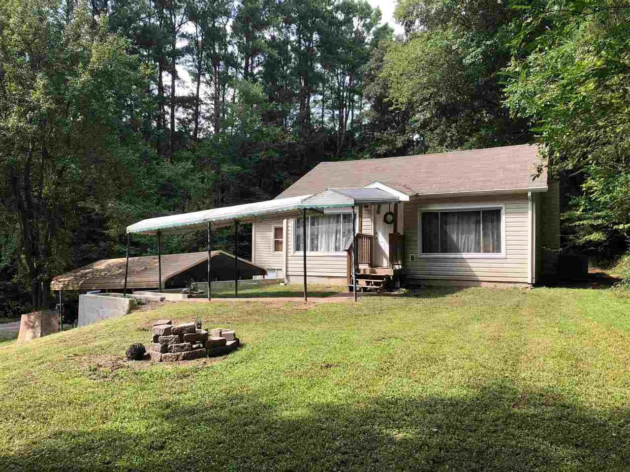 2000 Old River Road Charleston, TN 37310 - Photo 1 of 9 a view of a house with backyard sitting area and garden