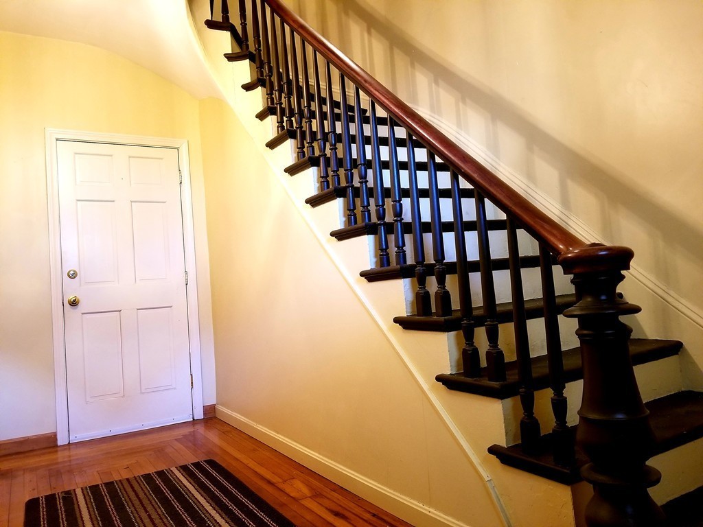126 Ridge Street Fall River, MA 02721 - Photo 2 of 28 a view of entryway with wooden floor and stairs
