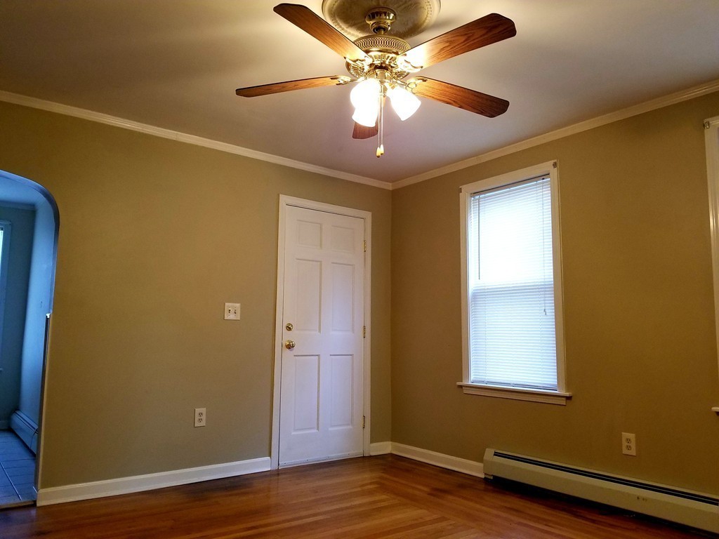 126 Ridge Street Fall River, MA 02721 - Photo 4 of 28 a view of an empty room with wooden floor and a window