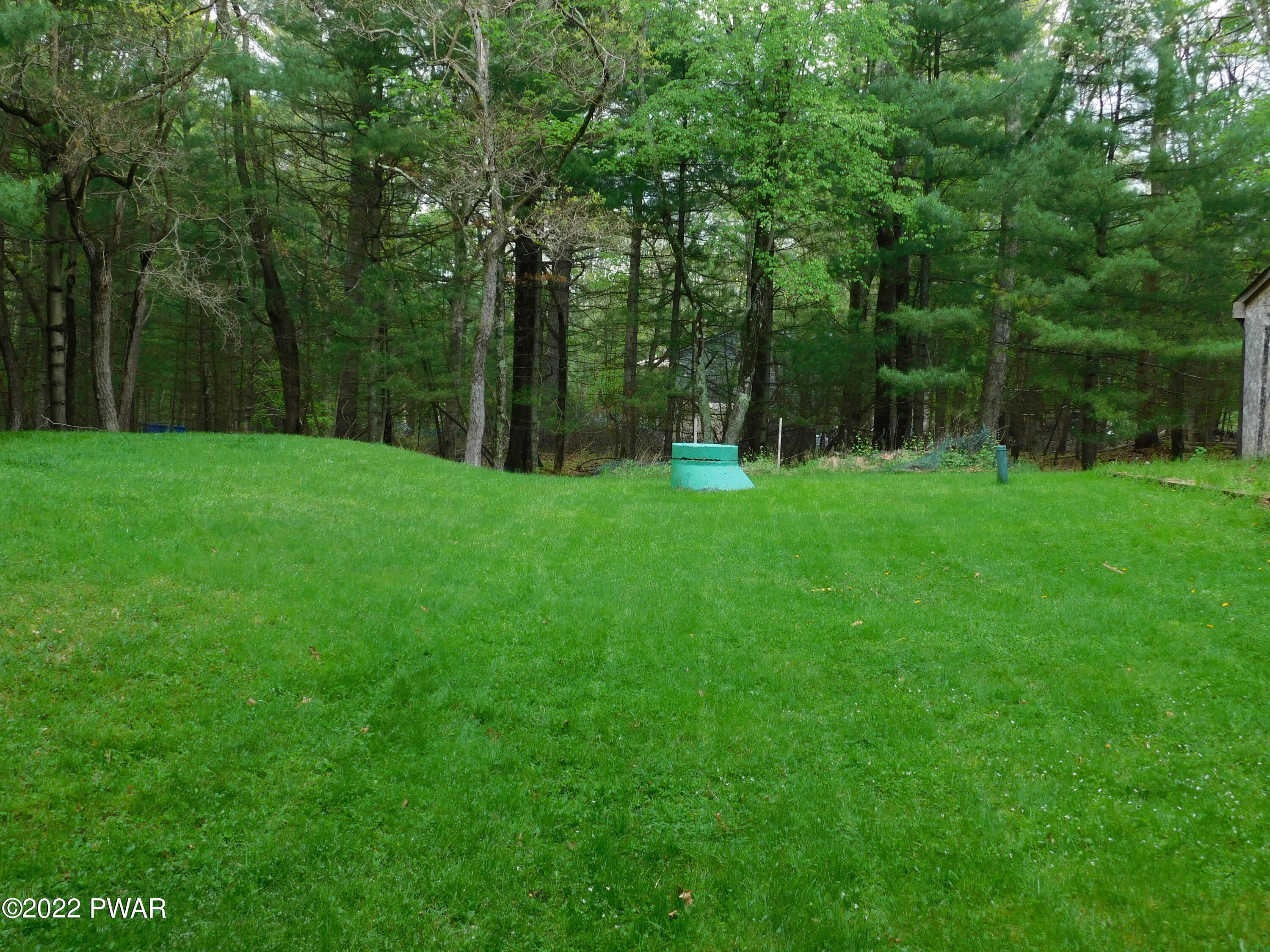 191 Fox Road Dingmans Ferry, PA 18328 - Photo 7 of 27 a view of a grassy field with trees in the background