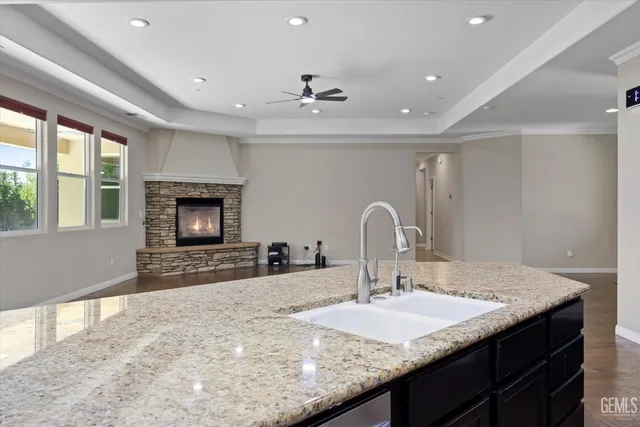a kitchen with granite countertop a sink and a stove