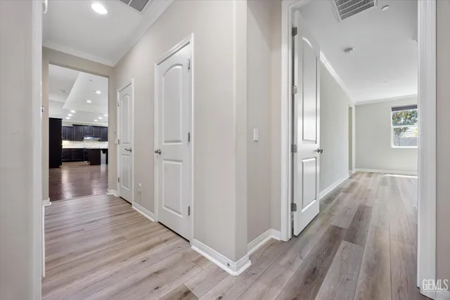 a view of a hallway with wooden floor