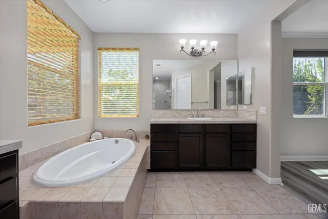 a bathroom with a bathtub sink and mirror