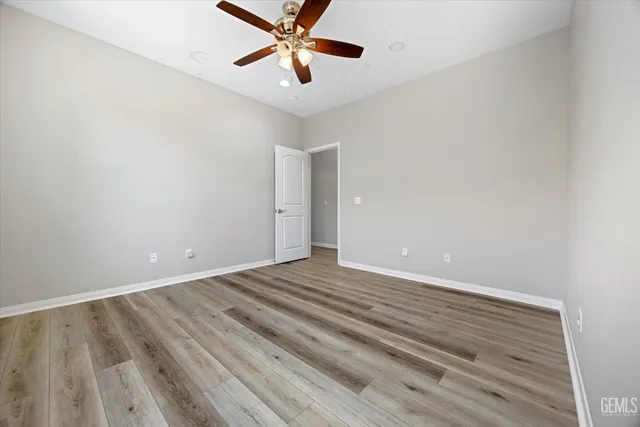 a view of an empty room and wooden floor