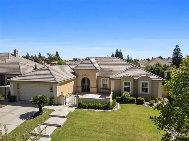 a front view of a house with yard patio and green space