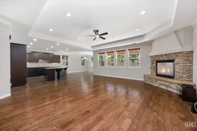 a view of an empty room with a fireplace and a window
