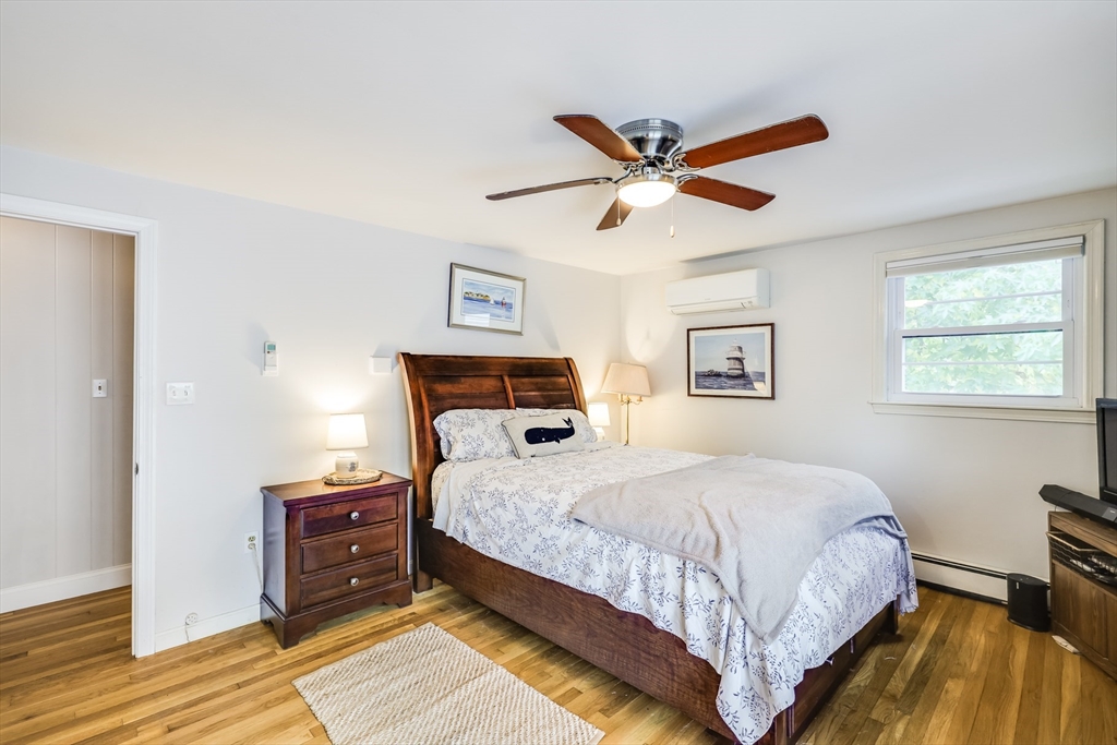 80 Sterling Road Barnstable, MA 02601 - Photo 11 of 19 a bedroom with a bed and wooden floor