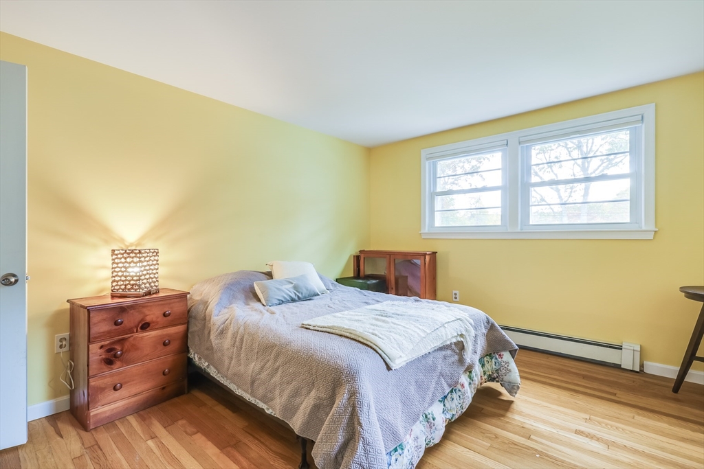 80 Sterling Road Barnstable, MA 02601 - Photo 13 of 19 a bedroom with a bed and wooden floor