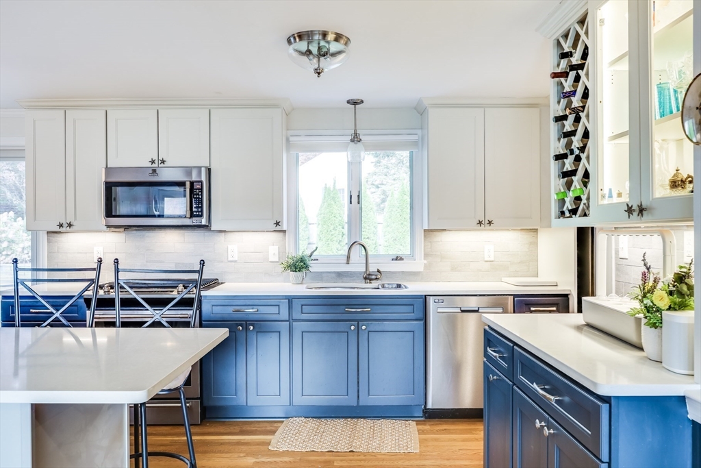 80 Sterling Road Barnstable, MA 02601 - Photo 2 of 19 a kitchen with kitchen island granite countertop a sink a counter space appliances and cabinets