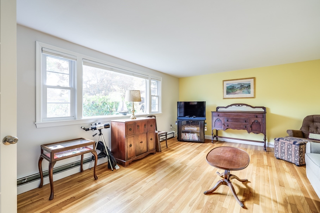 80 Sterling Road Barnstable, MA 02601 - Photo 9 of 19 a room with furniture a wooden floor and a flat screen tv