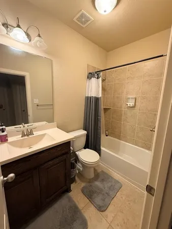 a bathroom with a sink a toilet a mirror and shower