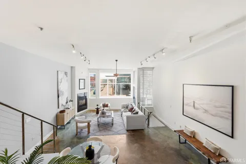 a living room with furniture a rug and a painting