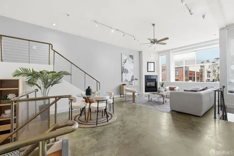 a dining room with furniture entryway and wooden floor