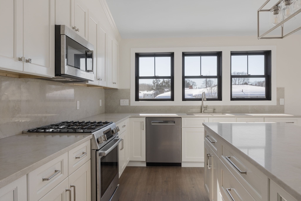 1864 River Street Boston, MA 02136 - Photo 1 of 38 a kitchen with stainless steel appliances granite countertop a sink stove and cabinets