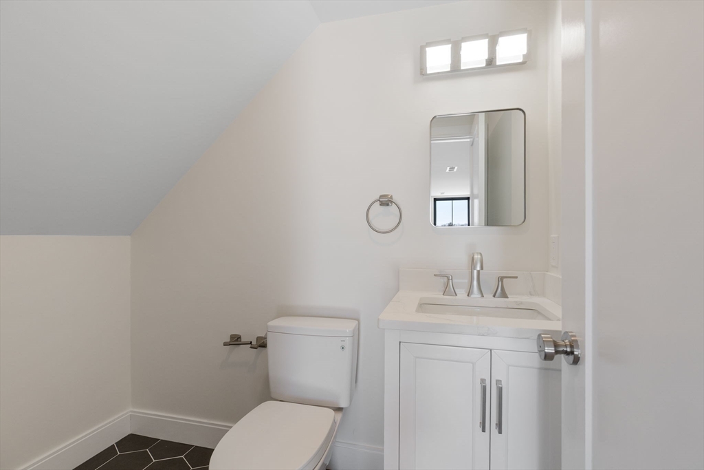 1864 River Street Boston, MA 02136 - Photo 30 of 38 a bathroom with a toilet sink vanity and mirror