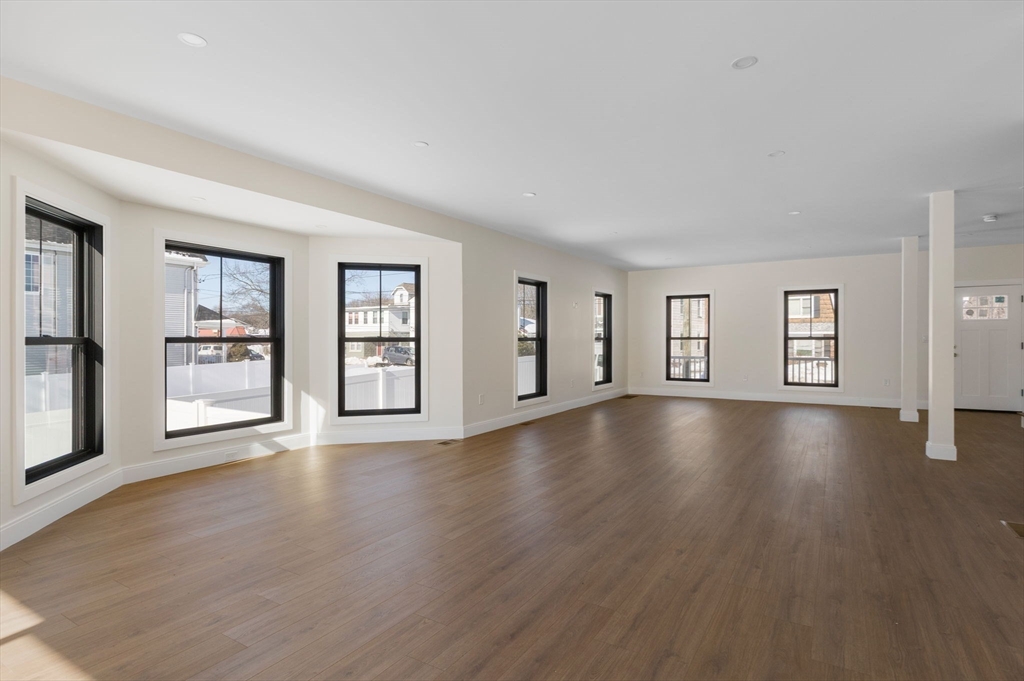 1864 River Street Boston, MA 02136 - Photo 8 of 38 a view of an empty room with window and wooden floor