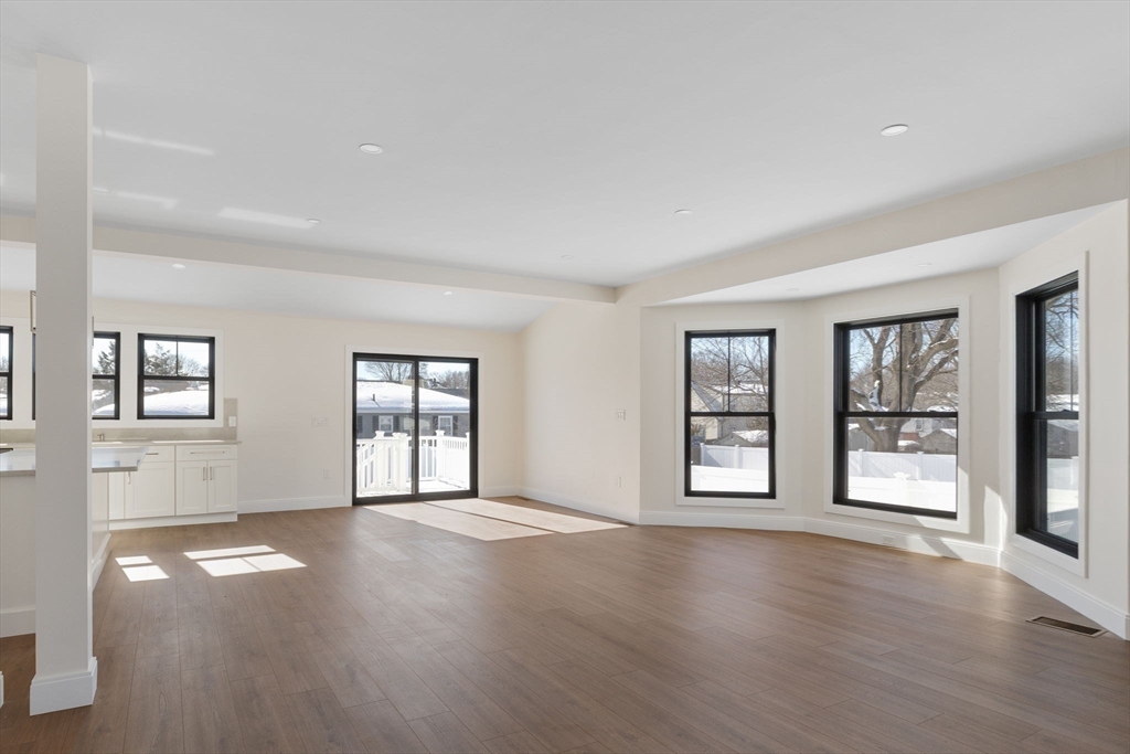 1864 River Street Boston, MA 02136 - Photo 10 of 38 a view of an empty room with window and wooden floor