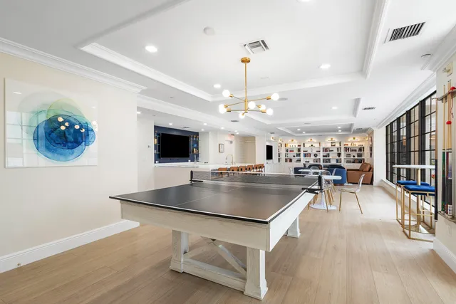 a kitchen with a table chairs refrigerator and dining table