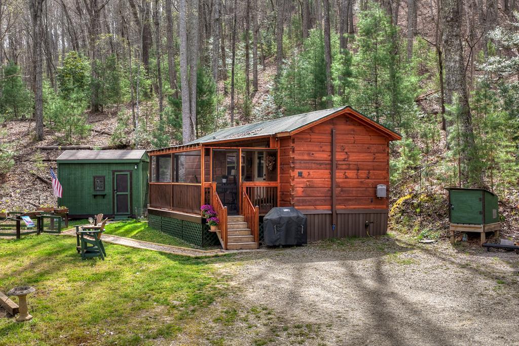 57 Meadow Hill Morganton, GA 30560 - Photo 12 of 59 a view of backyard with table and chairs and potted plants