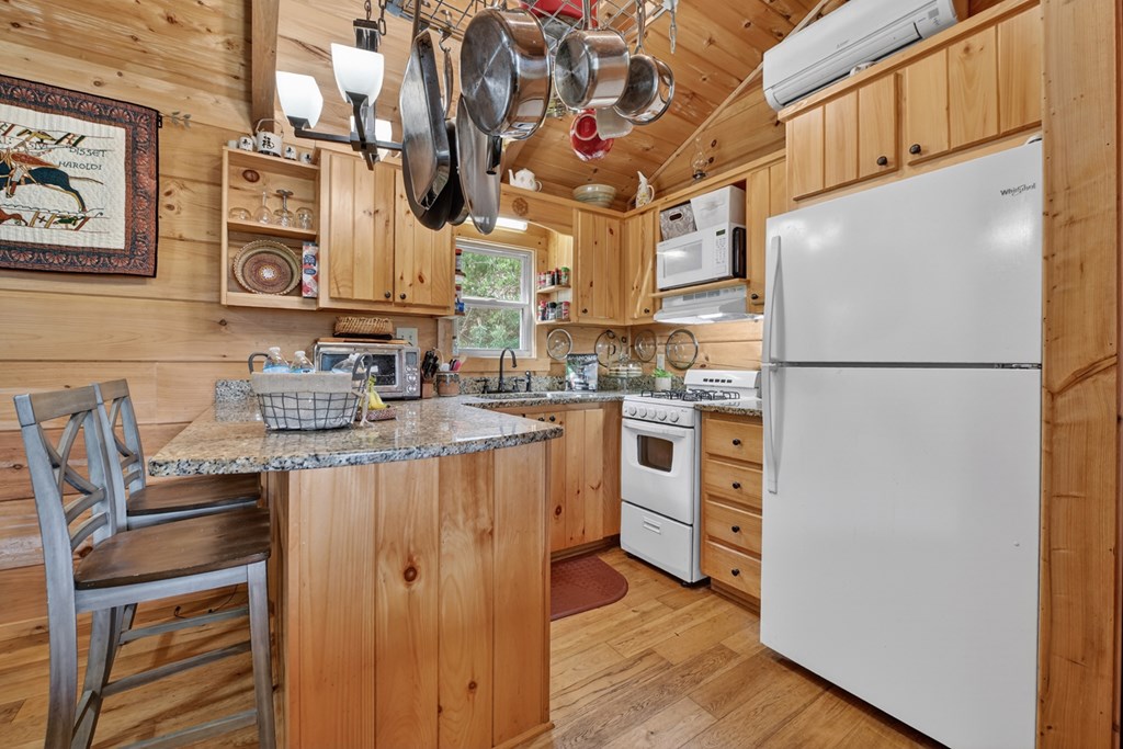 57 Meadow Hill Morganton, GA 30560 - Photo 19 of 59 a kitchen with stainless steel appliances granite countertop a refrigerator a stove and a sink with wooden floor