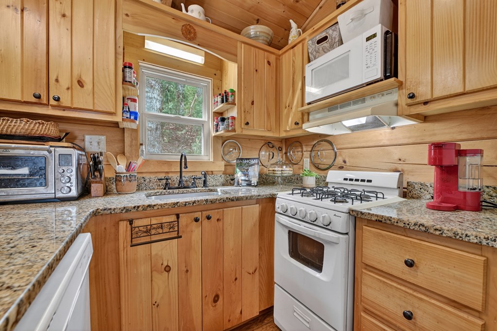 57 Meadow Hill Morganton, GA 30560 - Photo 20 of 59 a kitchen with stainless steel appliances granite countertop a stove and a sink
