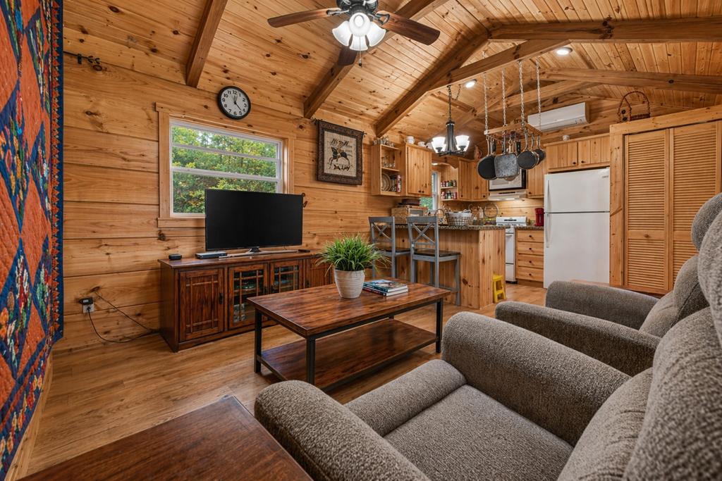57 Meadow Hill Morganton, GA 30560 - Photo 21 of 59 a living room with furniture a flat screen tv and a floor to ceiling window