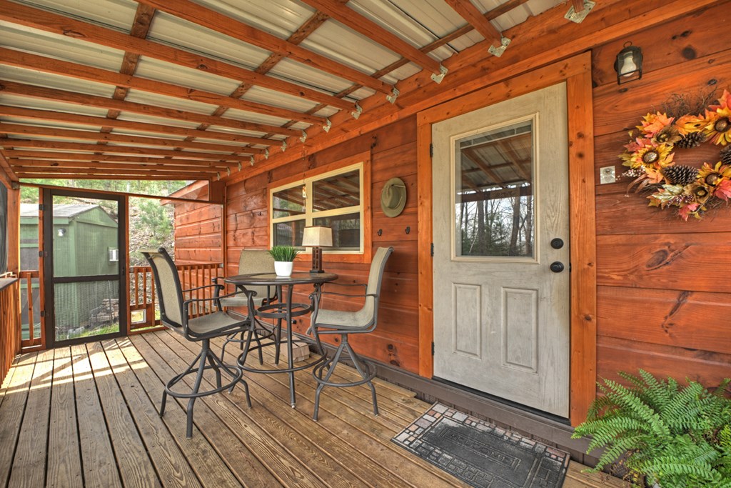 57 Meadow Hill Morganton, GA 30560 - Photo 53 of 59 a view of a patio with table and chairs and wooden floor