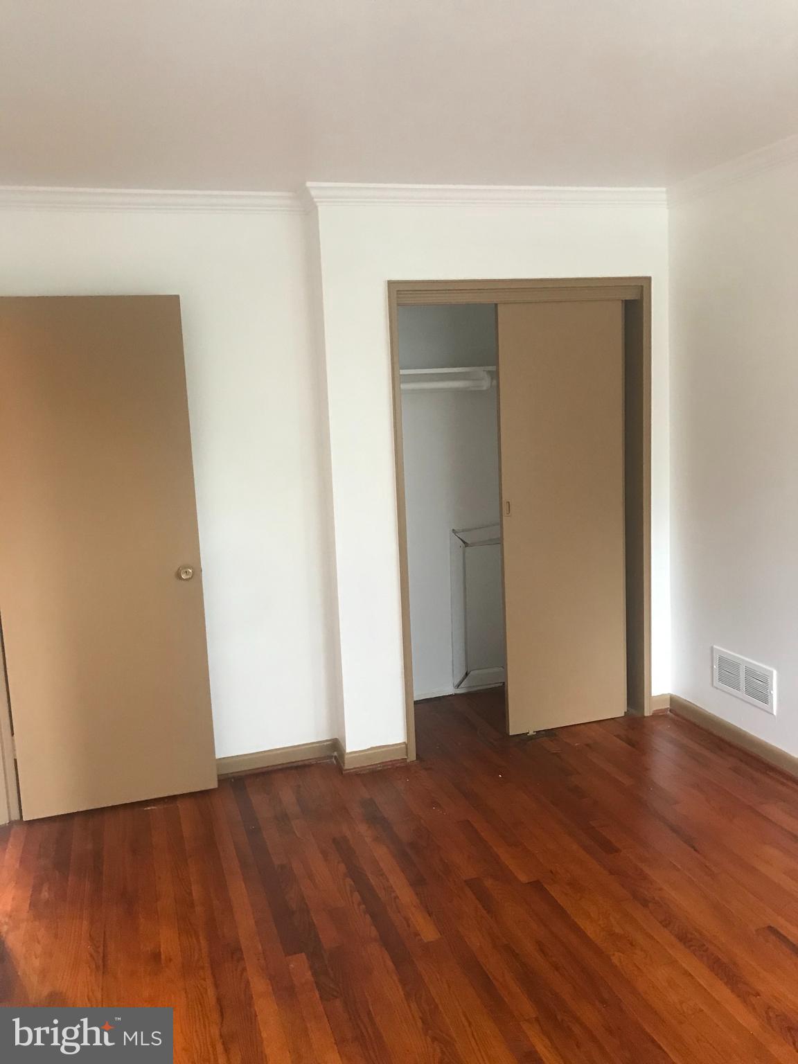 5920 Greentree Road Bethesda, MD 20817 - Photo 11 of 21 a view of an empty room with wooden floor and closet
