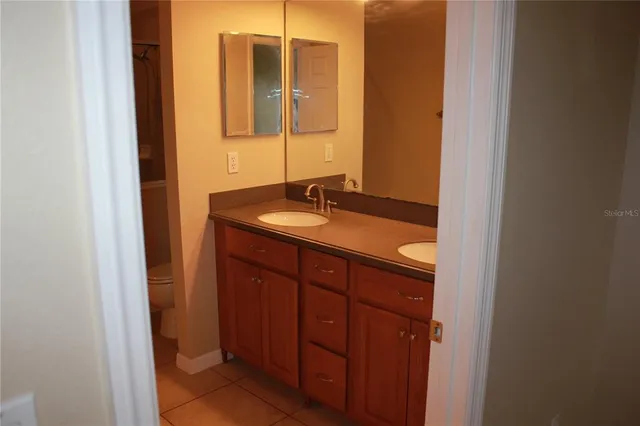 a view of a hallway with wooden floor and a window