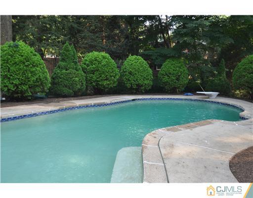 25 Hillwood Road East Brunswick, NJ 08816 - Photo 5 of 9 a view of a golf ground with large trees