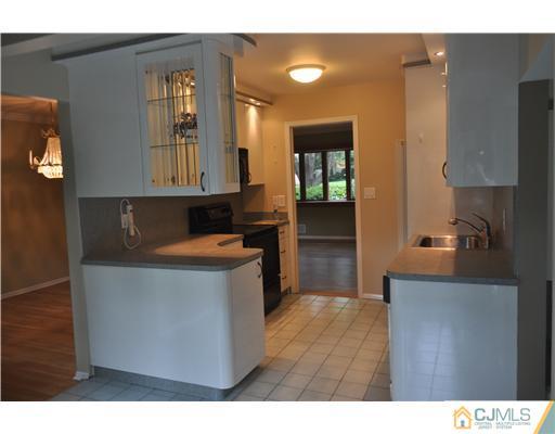 25 Hillwood Road East Brunswick, NJ 08816 - Photo 7 of 9 a kitchen that has a sink and a stove in it