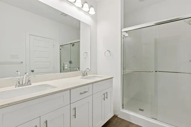a bathroom with a shower sink and mirror