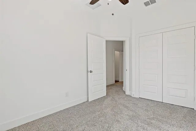 an empty room with closet area